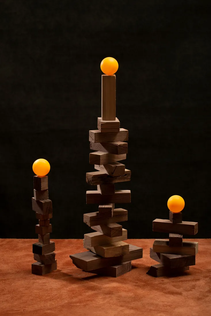 Balanced wooden blocks holding glowing spheres