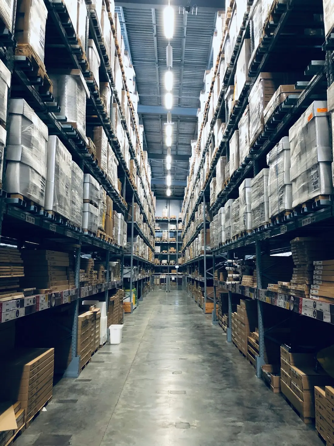 A warehouse aisle stacked with pallets