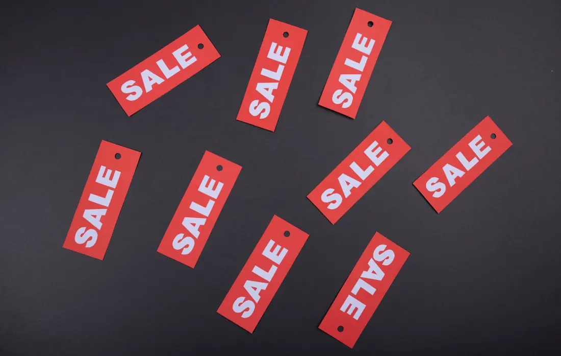 Sale tags arranged on a dark surface