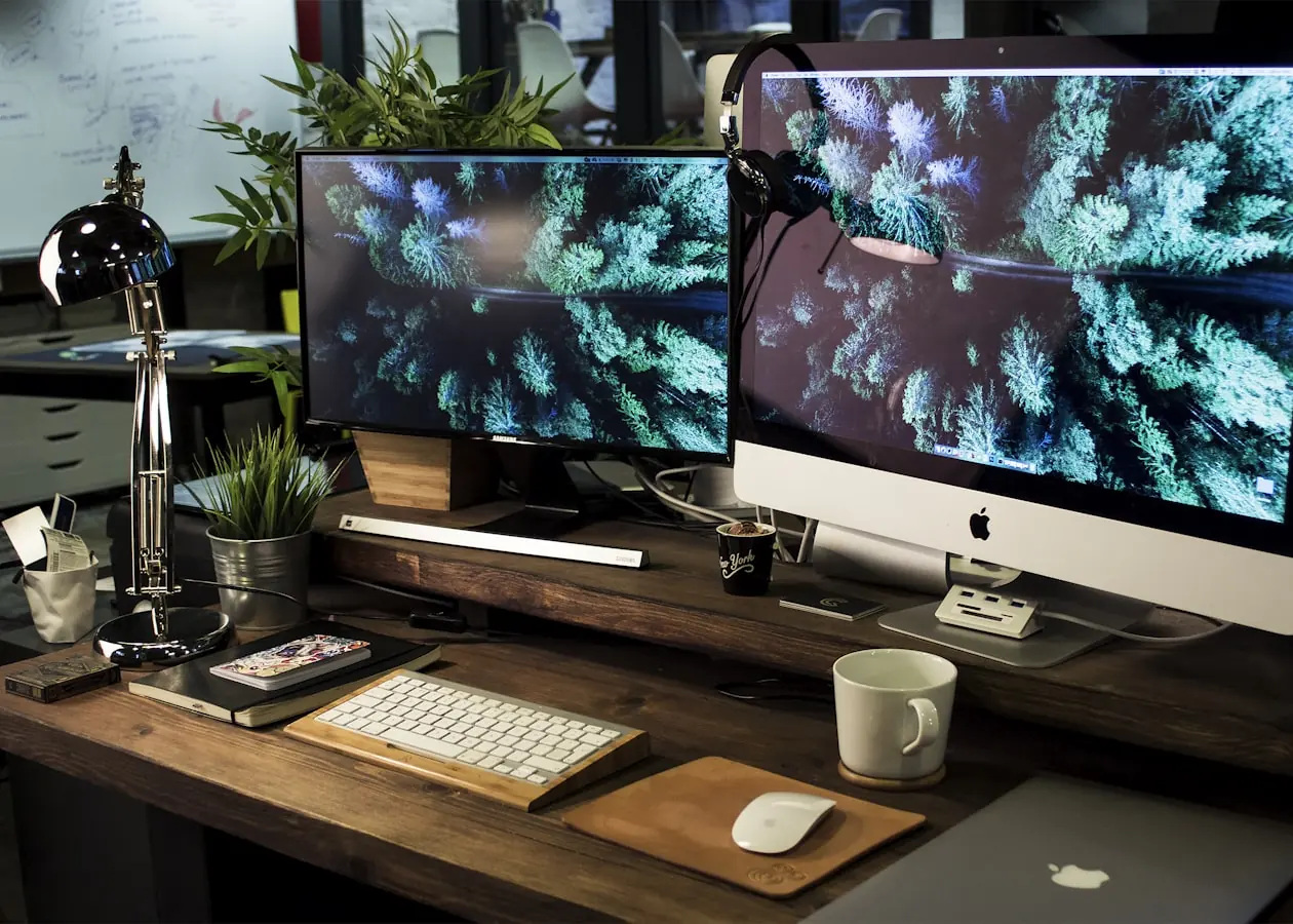 A clean desk workspace with a large display