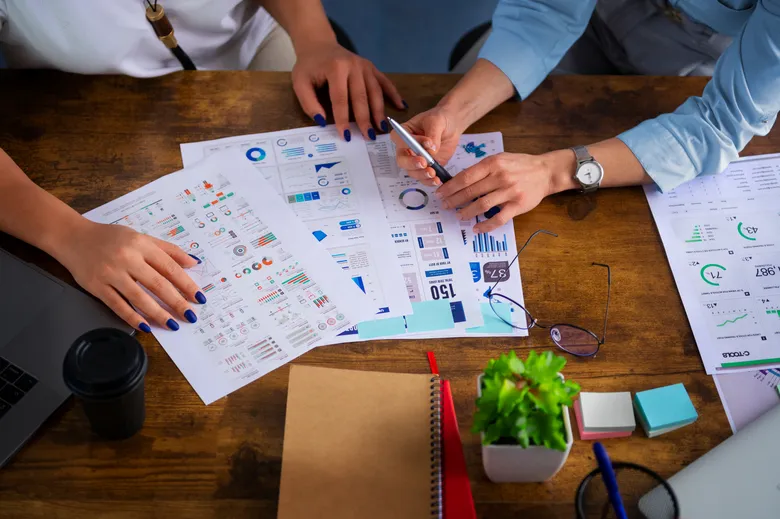 Colleagues reviewing campaign performance reports at a desk