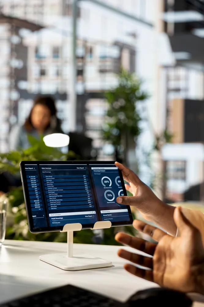 Consultant walking a client through a live marketing automation dashboard on a tablet