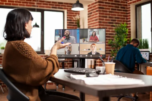 Presenter hosting a live webinar from a brick-walled office