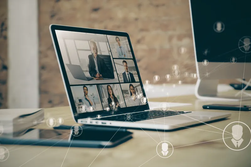 Laptop on a desk running a webinar session