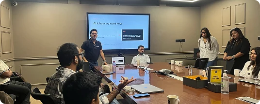 Voxturr team presenting to colleagues around a boardroom table